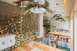 Babylon Lights with floral arrangements above tables in contemporary restaurant