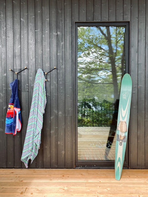 Yoke hooks on the exterior wall of a cottage with towels hanging on them