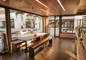 Babylon lights hanging above a long table in a smoothie shop