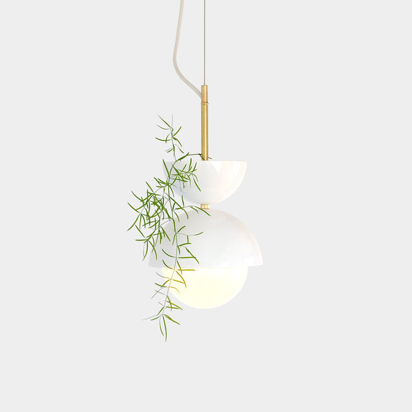 A plantable pendant light with a white opal glass diffuser and brass details.