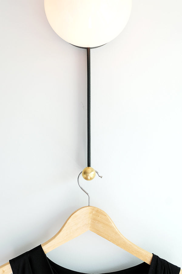 Modern wall light with integrated hook ideal for bedrooms and bathrooms designed by Object/Interface, Toronto, Canada