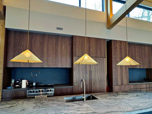 Brass screen pendant lights about kitchen counter in VFA architect design Manitouwabing Lake cottage muskoka