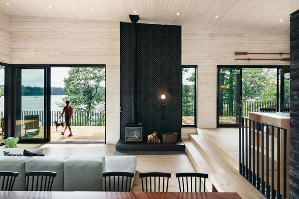 contemporary Muskoka cottage interior with modern furnishings and view of lake designed by VFA Architect
