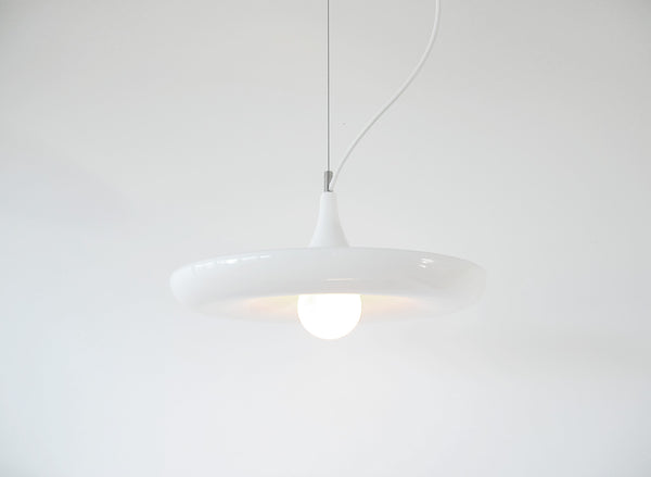 Babylon  Light with the light bulb on is a minimalist white plantable pendant lamp