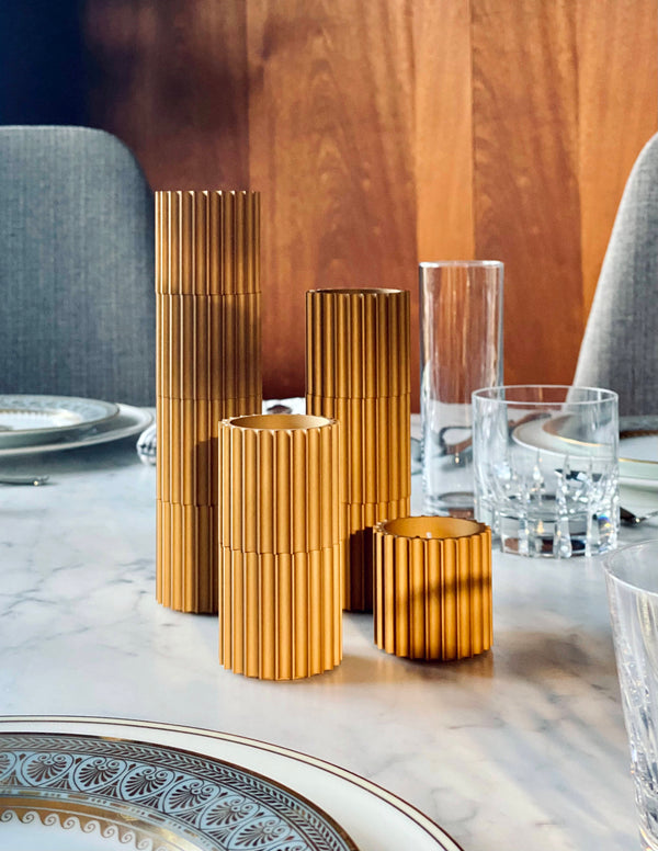 decorative gold candle sticks on marble table